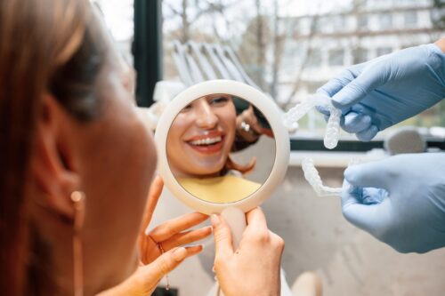 Person using mirror to look at cosmetic dental