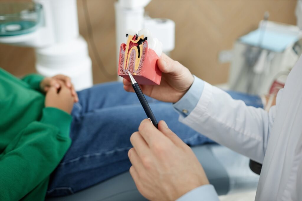 dentist going through root canal steps with patient