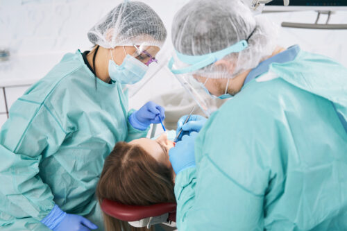 Dental workers performing a common dental procedure