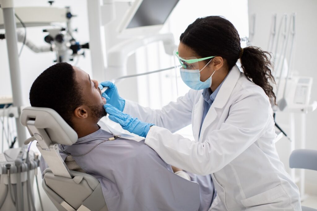 man getting a dental exam at his dental visit